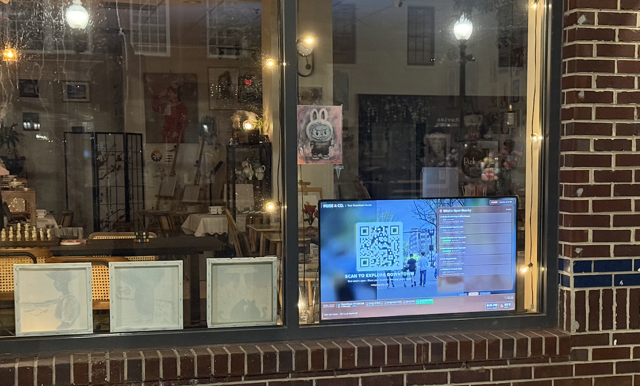 The Muse & Co storefront kiosk — Pi + RTL-SDR live behind the glass, public dashboard out front Muse & Co window display showing the live downtown dashboard